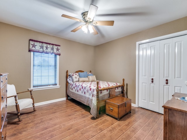 bedroom with ceiling fan, light hardwood / wood-style floors, and a closet