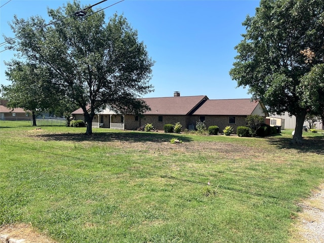 ranch-style home with a front lawn