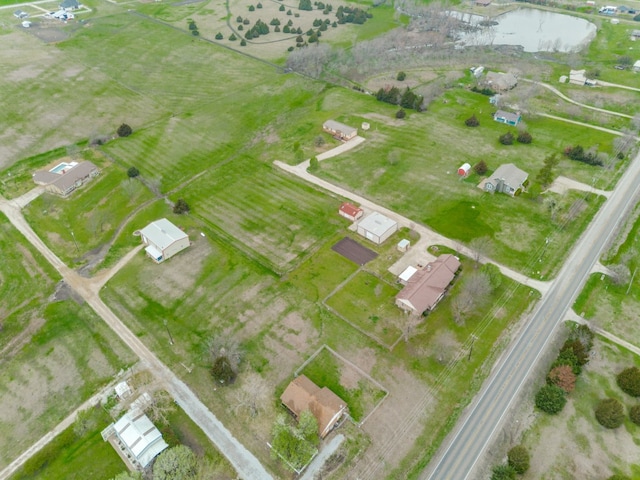 birds eye view of property featuring a rural view and a water view