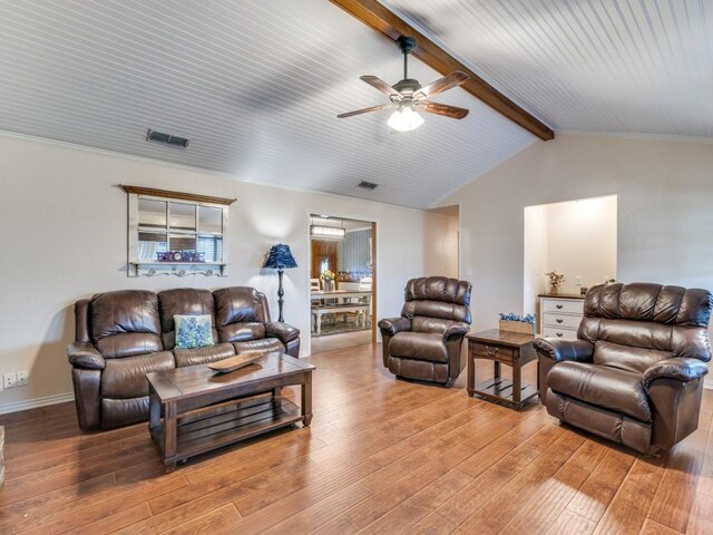 living room featuring hardwood / wood-style flooring, ceiling fan, and lofted ceiling with beams