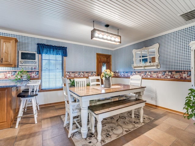 dining space with wood ceiling and ornamental molding