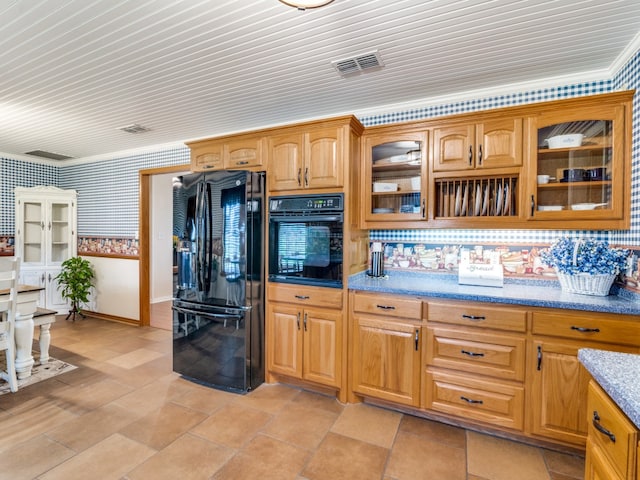 kitchen with black appliances, decorative backsplash, light stone countertops, and ornamental molding