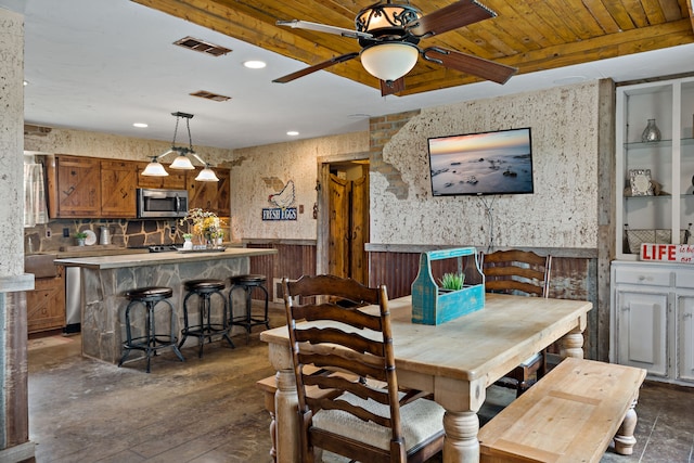 dining space with ceiling fan, dark wood-type flooring, and wood ceiling