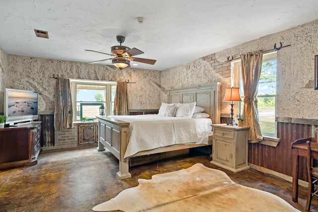 bedroom with multiple windows and ceiling fan