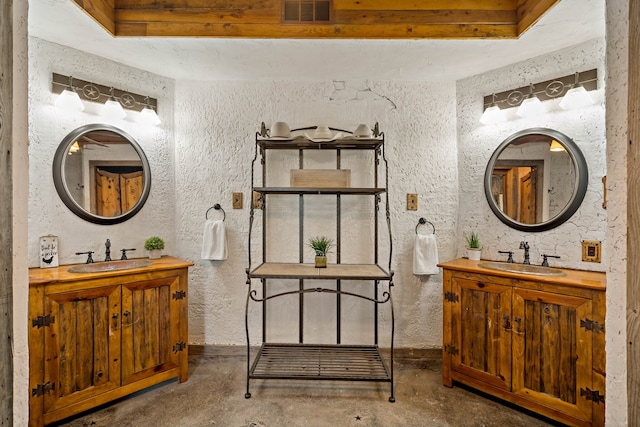 bathroom featuring beamed ceiling, vanity, and concrete floors