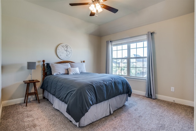 carpeted bedroom with vaulted ceiling and ceiling fan