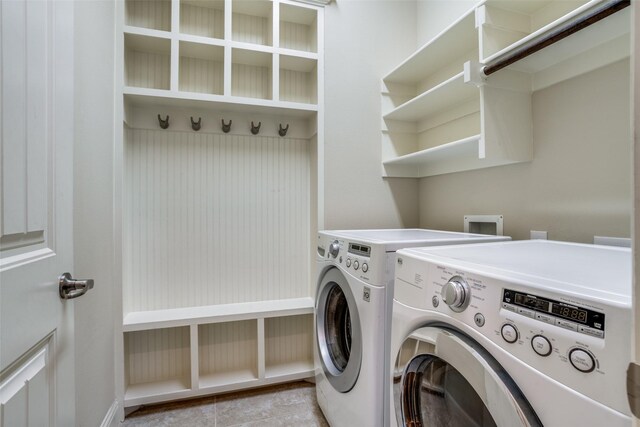 clothes washing area with light tile patterned flooring and washing machine and clothes dryer