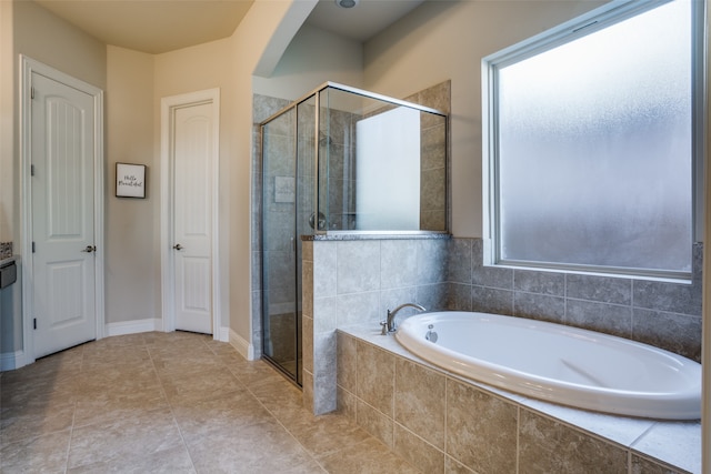 bathroom featuring tile patterned floors, separate shower and tub, and a healthy amount of sunlight