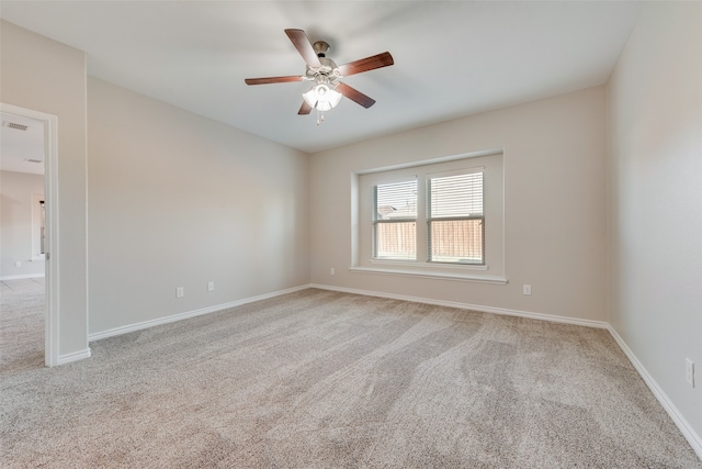 unfurnished room featuring light carpet and ceiling fan