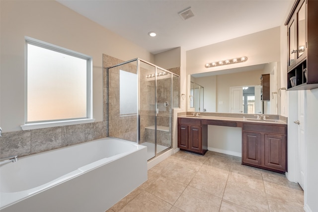 bathroom with plus walk in shower, vanity, and tile patterned floors