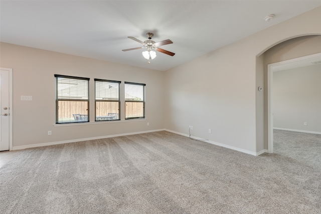 unfurnished room with light colored carpet and ceiling fan