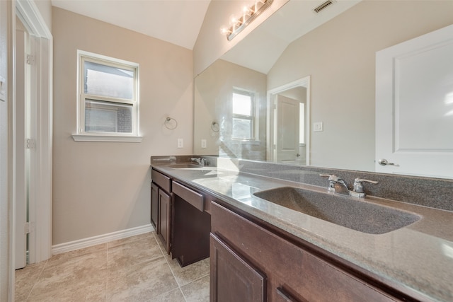 bathroom featuring tile patterned floors, vanity, and lofted ceiling