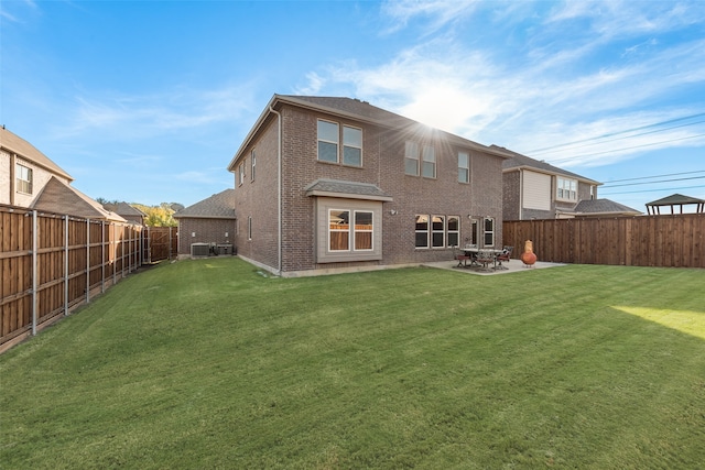 back of property with a patio, cooling unit, and a lawn