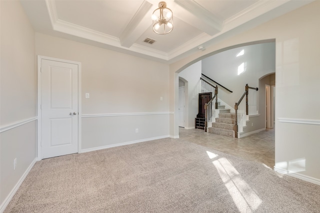 empty room featuring beamed ceiling, light colored carpet, crown molding, and a chandelier