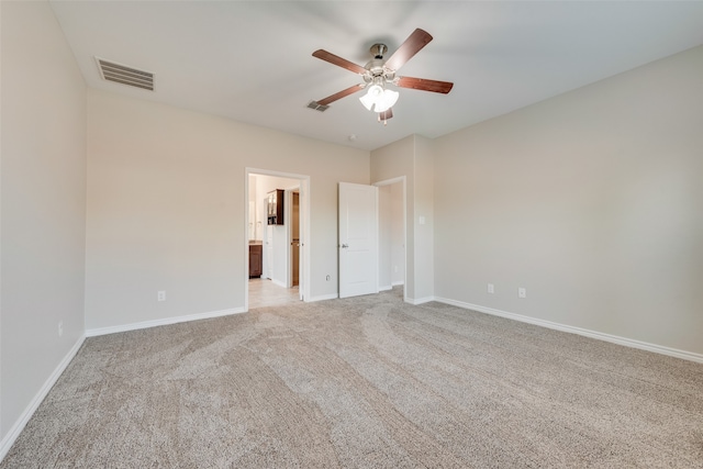 carpeted spare room featuring ceiling fan