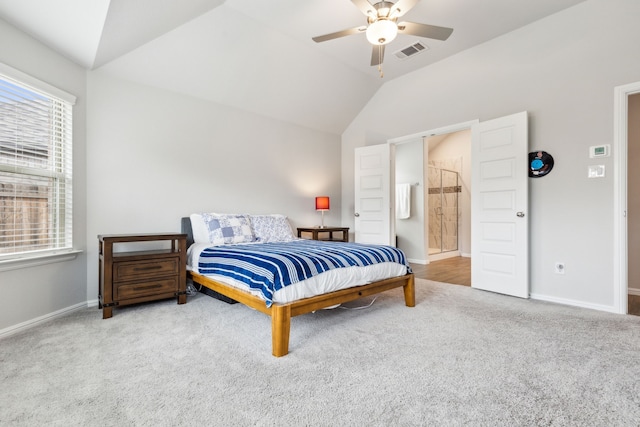 bedroom featuring carpet flooring, ensuite bathroom, vaulted ceiling, and ceiling fan