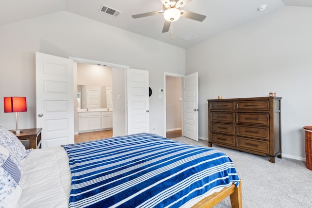 carpeted bedroom featuring ensuite bathroom, ceiling fan, and vaulted ceiling