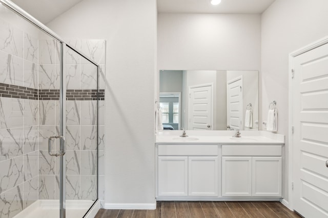 bathroom featuring hardwood / wood-style floors, vanity, and walk in shower