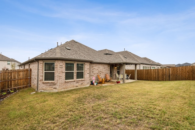 back of house featuring a yard and a patio