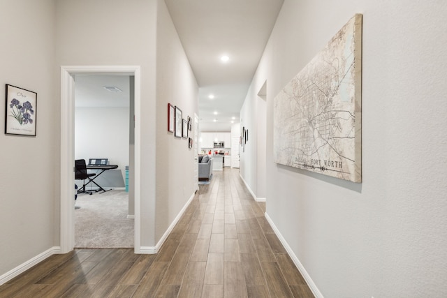 corridor with dark hardwood / wood-style flooring