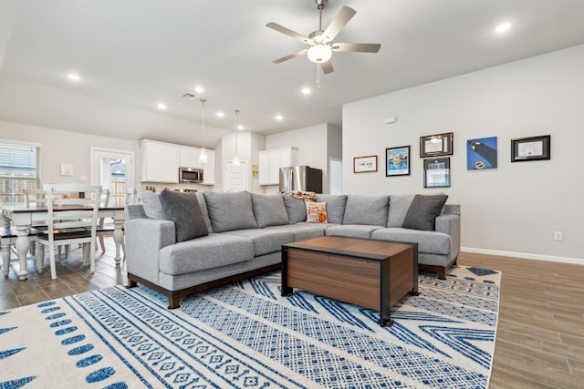 living room with hardwood / wood-style flooring and ceiling fan