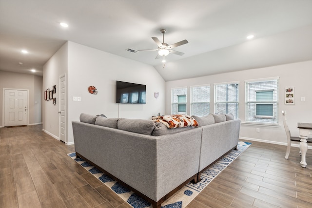 living room with ceiling fan, hardwood / wood-style floors, and vaulted ceiling