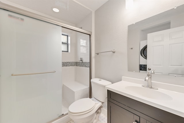 bathroom featuring vanity, an enclosed shower, stacked washer and clothes dryer, and toilet