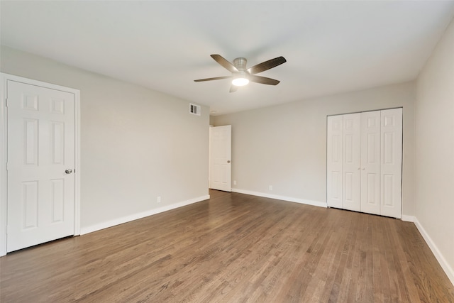 unfurnished bedroom with ceiling fan and hardwood / wood-style floors