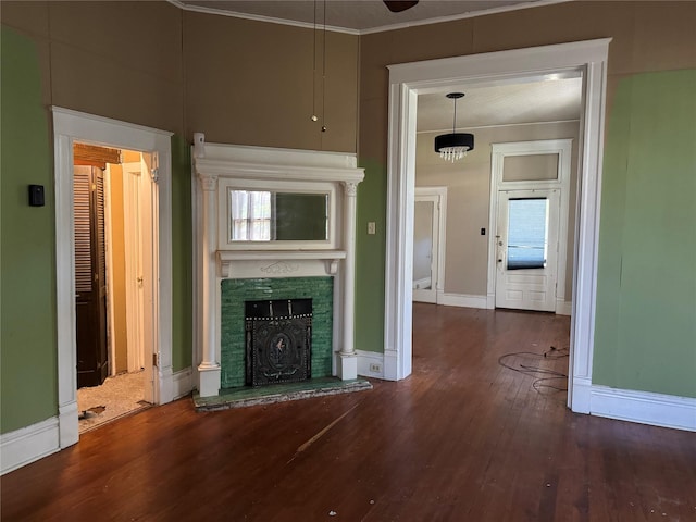 unfurnished living room with crown molding and dark hardwood / wood-style flooring