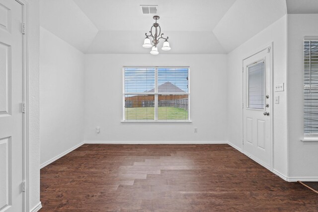 unfurnished dining area featuring vaulted ceiling, an inviting chandelier, and dark wood-type flooring