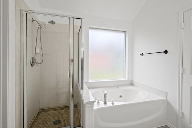 bathroom featuring separate shower and tub, vaulted ceiling, and a wealth of natural light