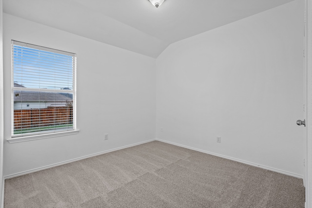 unfurnished room featuring carpet floors and lofted ceiling