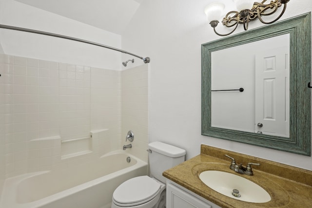 full bathroom featuring vanity, toilet, lofted ceiling, and washtub / shower combination