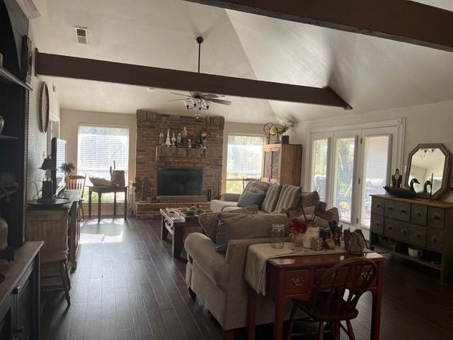 living room with vaulted ceiling with beams, ceiling fan, dark hardwood / wood-style flooring, and a fireplace