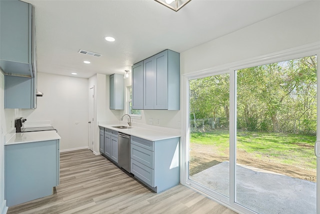 kitchen featuring gray cabinetry, dishwasher, sink, light wood-type flooring, and range