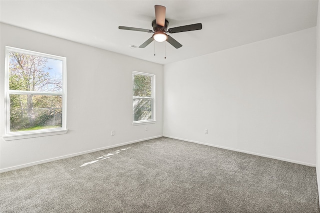 carpeted empty room with ceiling fan and a healthy amount of sunlight