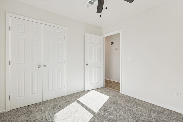 unfurnished bedroom featuring carpet, a closet, and ceiling fan