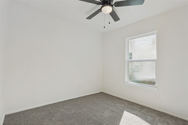 unfurnished room with ceiling fan and dark colored carpet