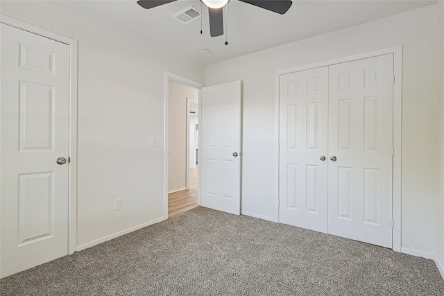 unfurnished bedroom with carpet flooring, a closet, and ceiling fan