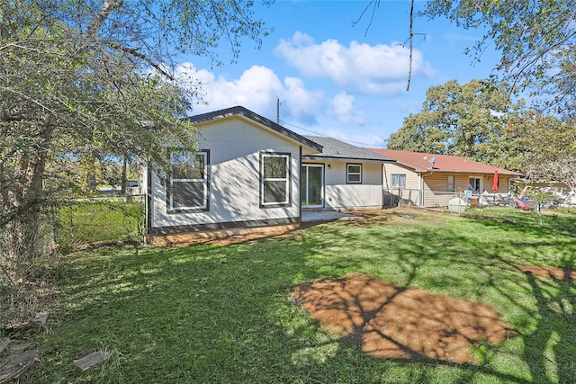 rear view of property with a yard