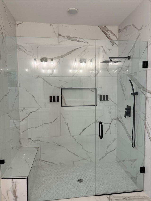 bathroom with a shower with shower door