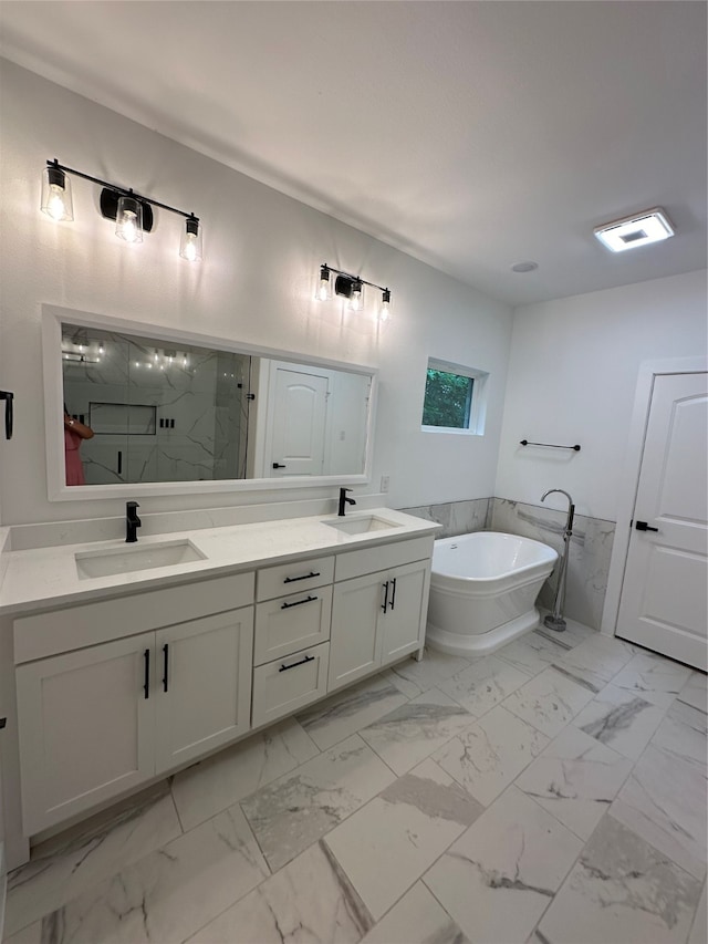 bathroom with vanity and independent shower and bath