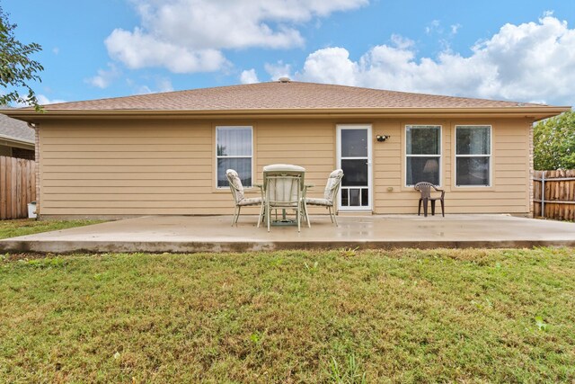 back of house with a lawn and a patio area