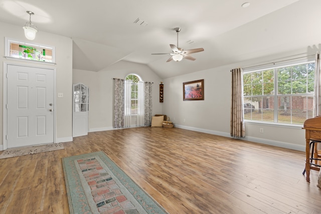 entryway with a wealth of natural light, ceiling fan, light hardwood / wood-style floors, and lofted ceiling