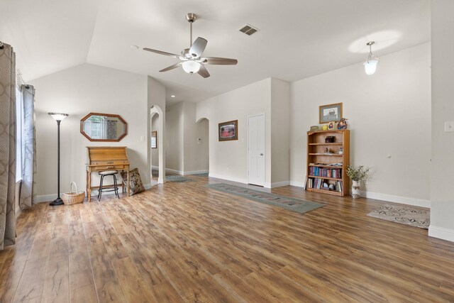 unfurnished living room with hardwood / wood-style floors, vaulted ceiling, and ceiling fan