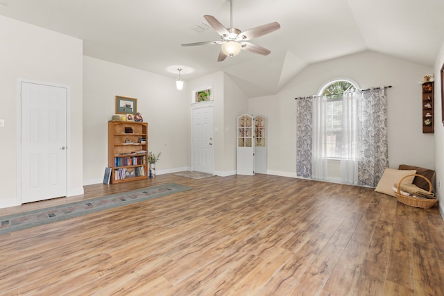 interior space featuring hardwood / wood-style floors, ceiling fan, and vaulted ceiling