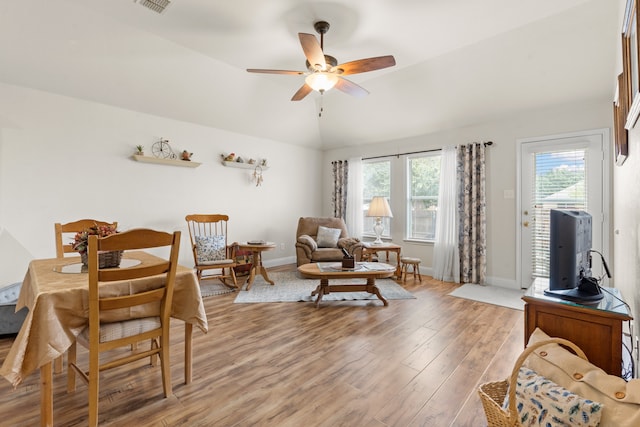 living area with light wood-type flooring, vaulted ceiling, and ceiling fan