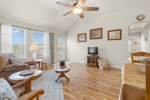 living room featuring vaulted ceiling, light hardwood / wood-style flooring, and ceiling fan