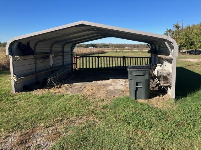 exterior space with a rural view and a carport