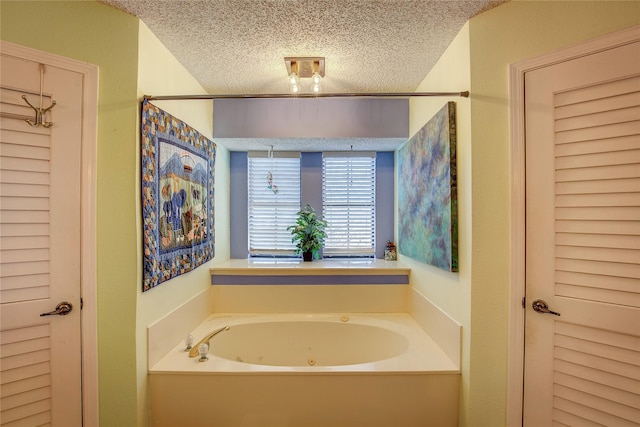 bathroom featuring a washtub and a textured ceiling